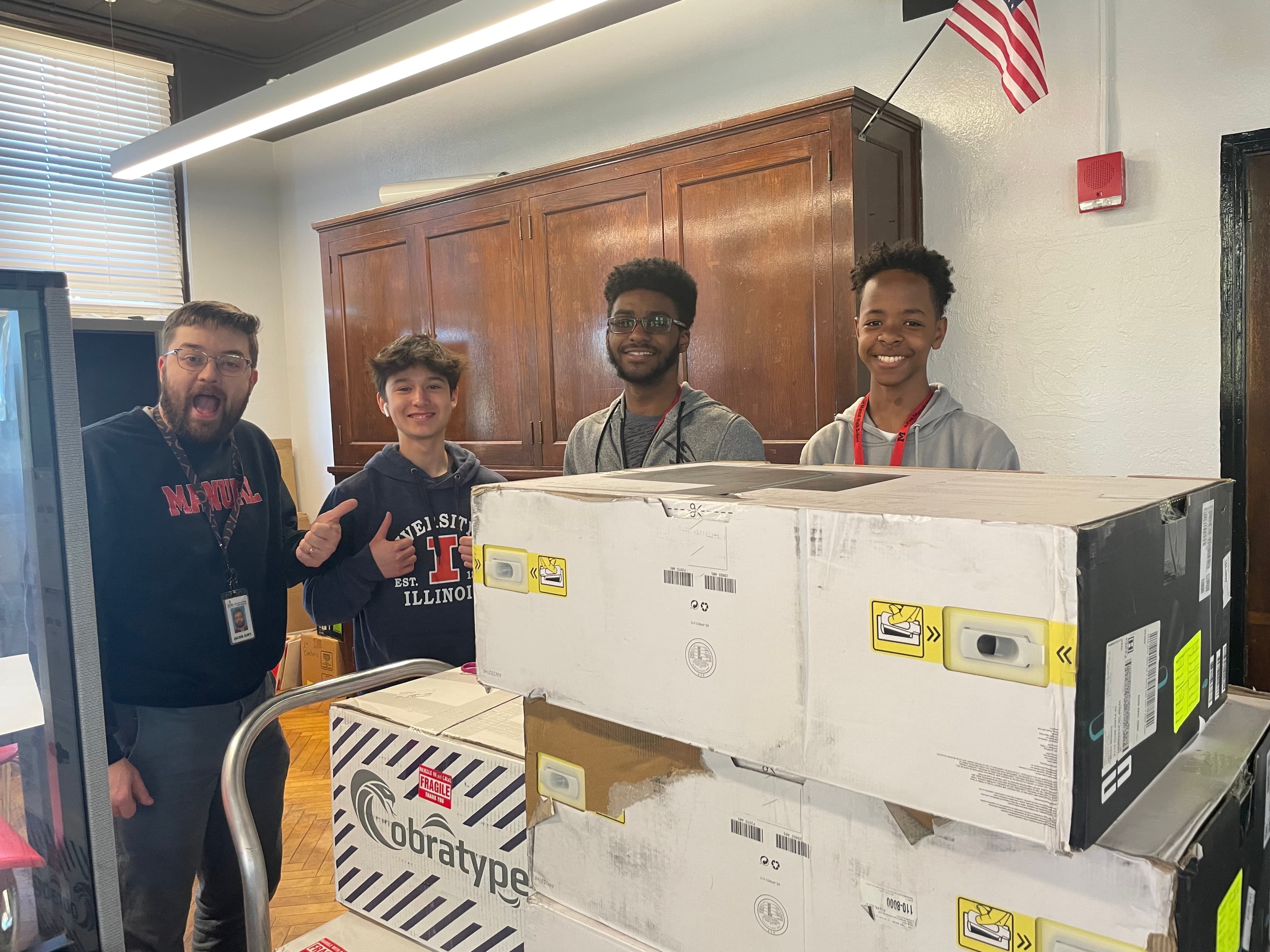 duPont Manual Esports - Players and coach with donated equipment boxes